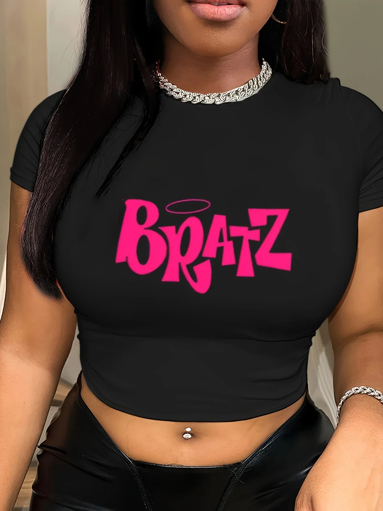 Trendy black Bratz shirt featuring bold pink lettering, perfect for fans of the iconic brand and stylish casual wear